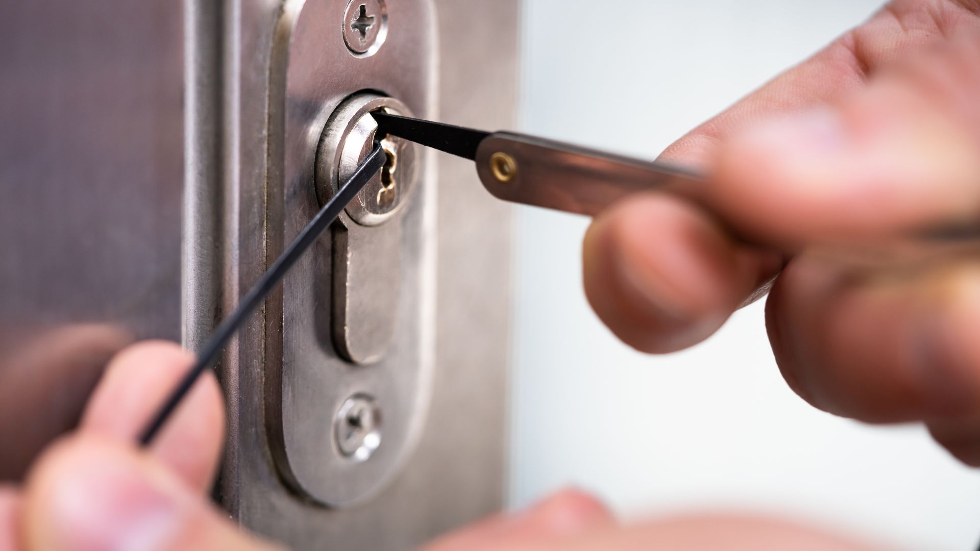 A person opening a door with a pair of scissors